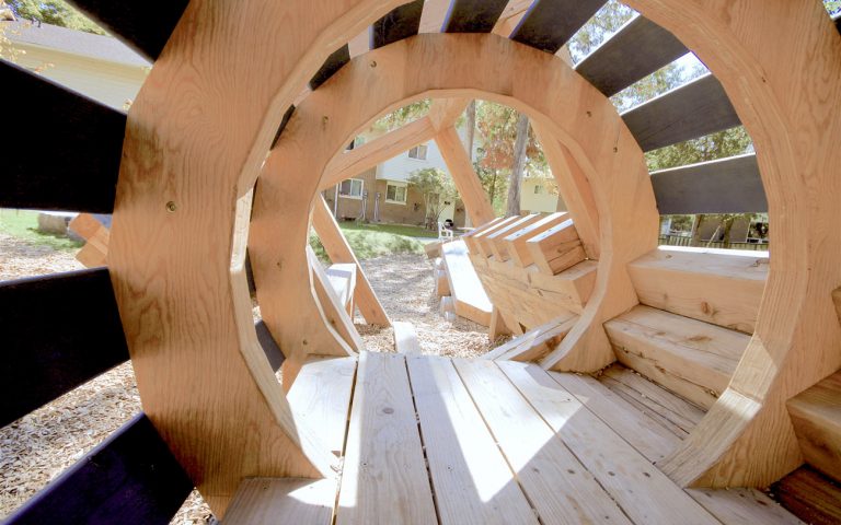 train themed wood sculpture tunnel