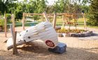 natural playground wood calgary park canoe sculpture