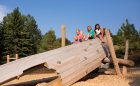 wood sculpture custom natural playground calgary climbing voyageur canoe