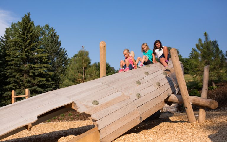 wood sculpture custom natural playground calgary climbing voyageur canoe