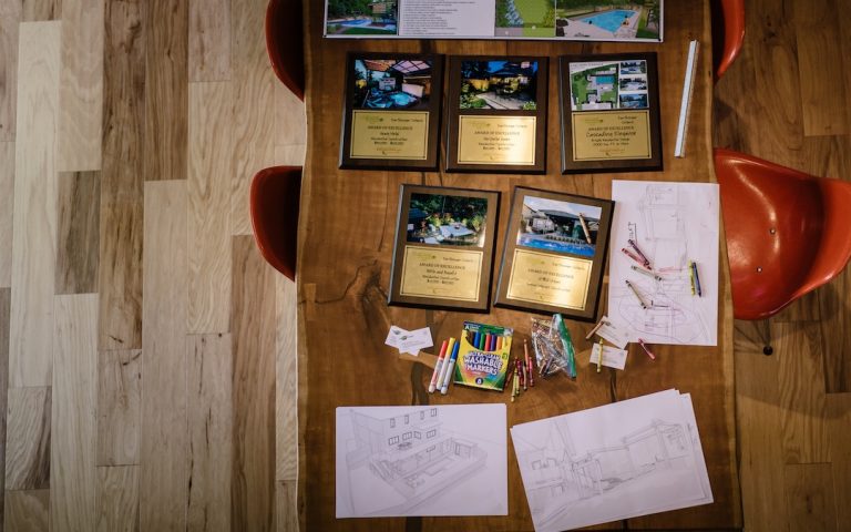 awards and sketches on tabletop of new design studio