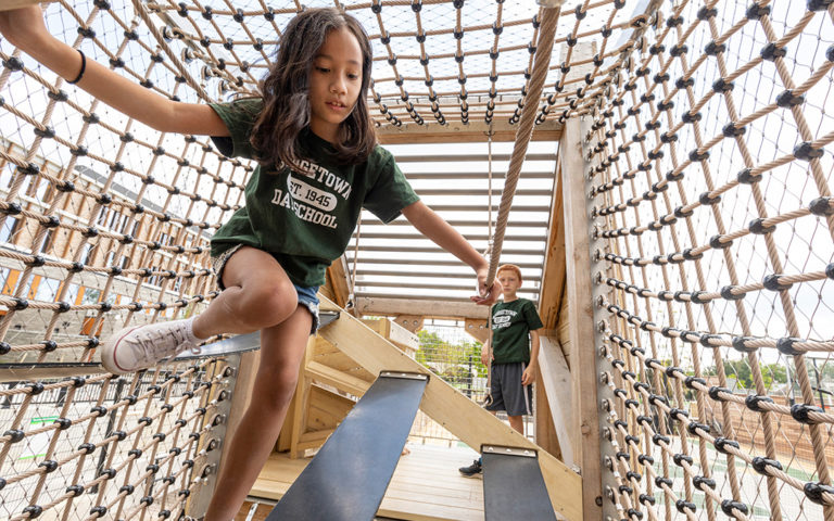 Wood bridge and flexform hangout climber playground equipment.