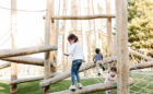 natural wood playground with spiral log jam climber net climber balance