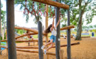 Amira Tomball Texas natural wood playground trapeze rings monkey bars robinia climber