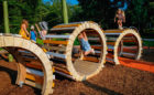 natural playground wood sculpture climbing swinging accessible caterpillar