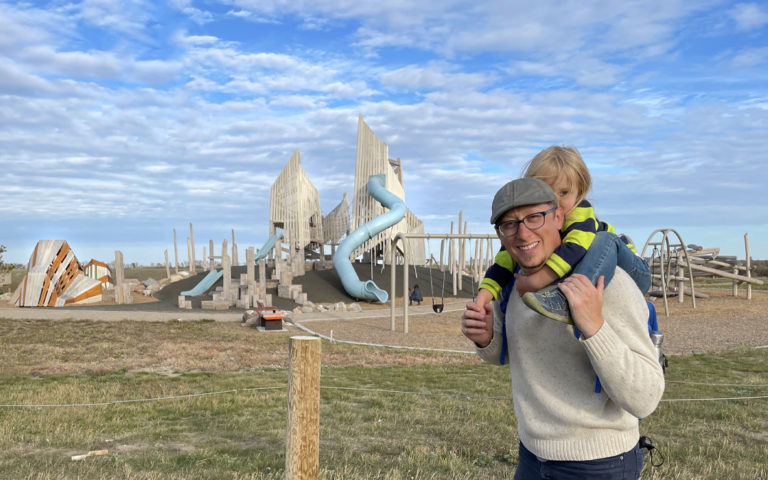 Wanuskewin Heritage Park playground designer Nathan Schleicher and his son pose in front of the playground.