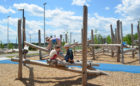 Children on logs at Churchill Meadows playground in Mississauga