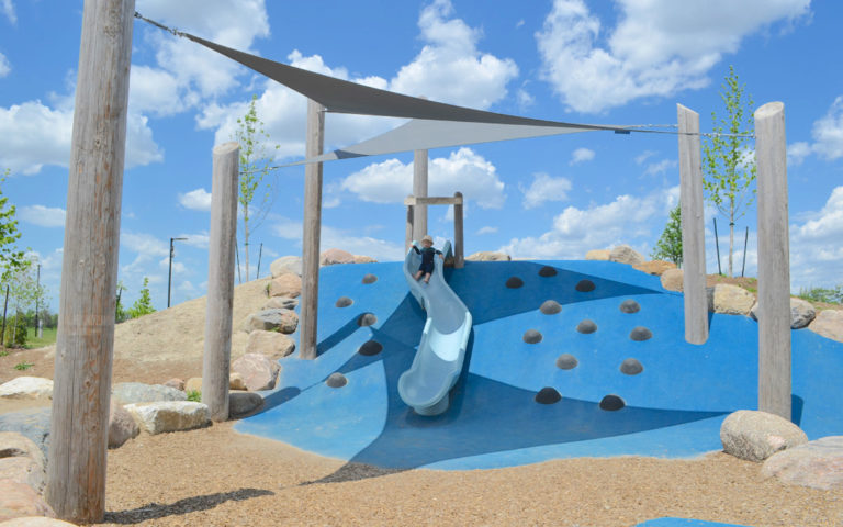 Shade sail covers a plastic hill slide at Churchill Meadows in Mississauga Ontario