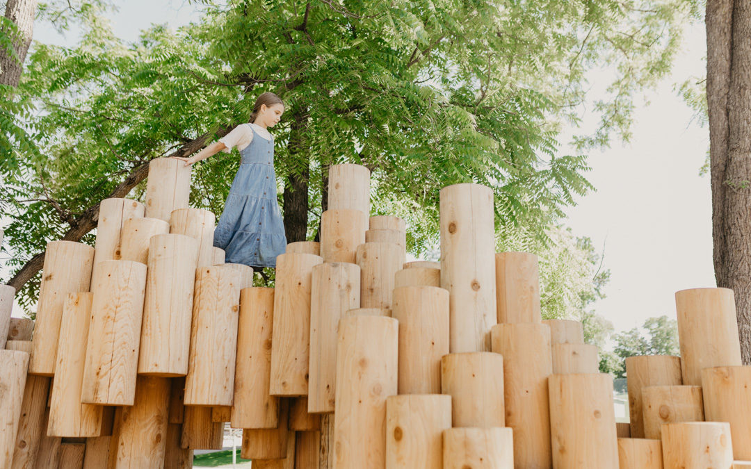 Girl climbs on Moku Yama public art sculpture by Earthscape and Kengo Kuma