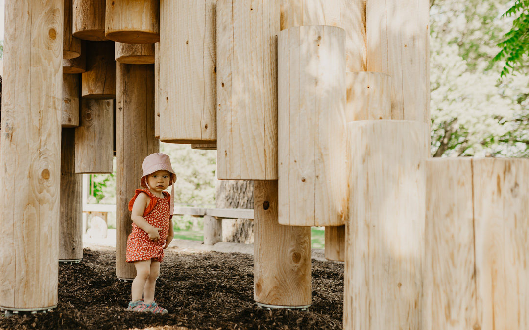 Toddler underneath Moku Yama playground by Earthscape Collections