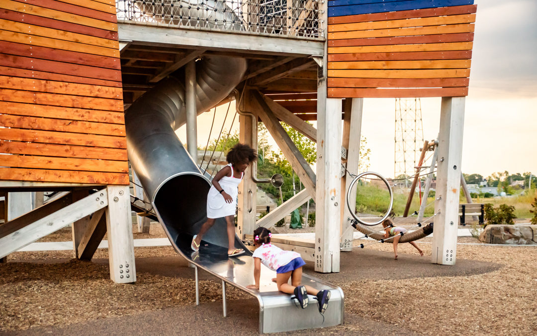 Glass City Metropark playground towers with stainless steel slide and kids at play