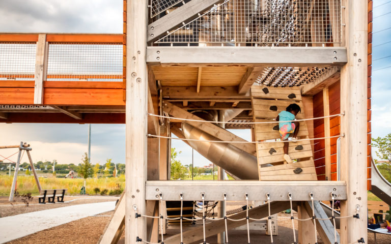 Playground towers in Ohio with climbing wall access and net floor